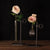 Glass bud vases on metal frames with pink roses